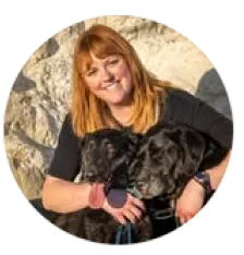 Brittany, K9 Harmony trainer, with her two black dogs